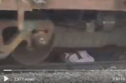 Man lies down on tracks while train passes over his head viral video