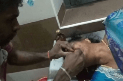 hospital worker stitches up womans wound